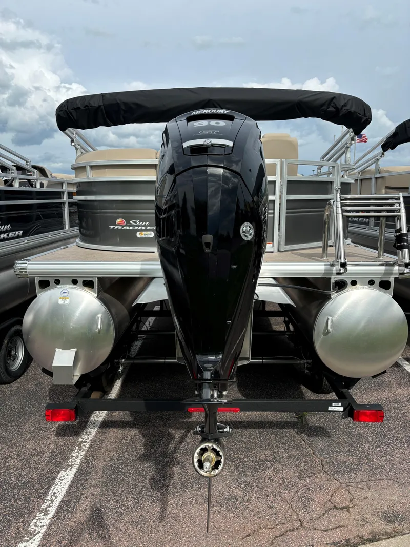Slide: The Image of 2024 Sun Tracker Party Barge 20 DLX pontoon boat rear view with outboard motor. - 5