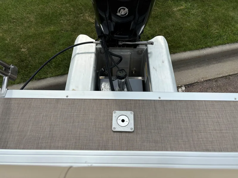 Slide: The Image of 2024 Sun Tracker Party Barge 20 DLX rear view with outboard motor and deck. - 9