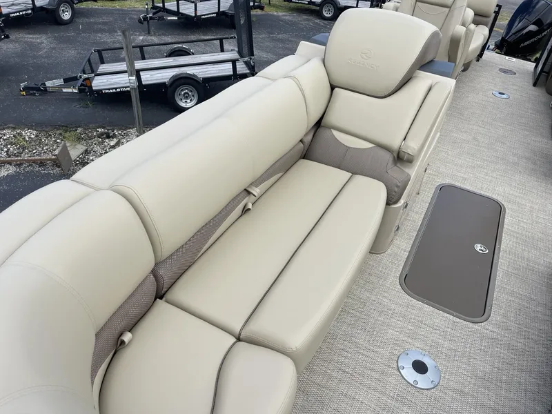 Slide: The Image of 2024 Regency 230 DL3 boat interior with beige seating and storage compartments. - 11
