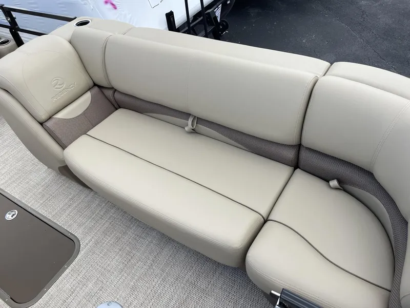 Slide: The Image of 2024 Regency 230 DL3 boat with beige cushioned seating. - 12
