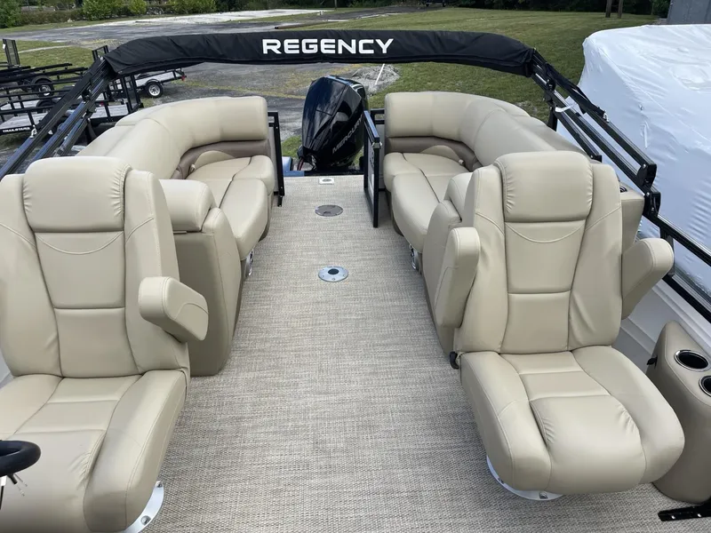 Slide: The Image of 2024 Regency 230 DL3 pontoon boat with beige leather seating. - 6