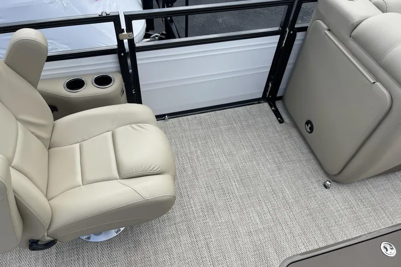 Slide: The Image of 2024 Regency 230 DL3 boat interior with beige seating and carpet flooring. - 9