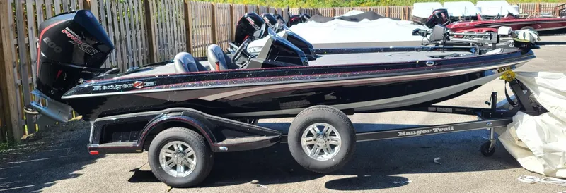 Slide: The Image of 2024 Ranger Z518 Garmin Ranger Cup boat on trailer, parked outdoors. - 0