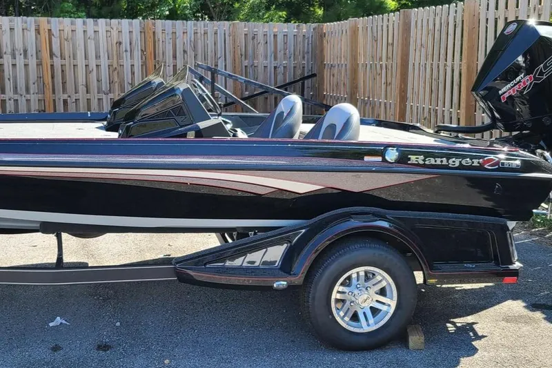 Slide: The Image of 2024 Ranger Z518 Garmin Ranger Cup boat, sleek design, parked outdoors. - 1