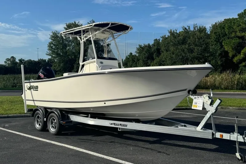The Image of 2024 Mako 214 CC boat on a trailer in a parking lot. - 0