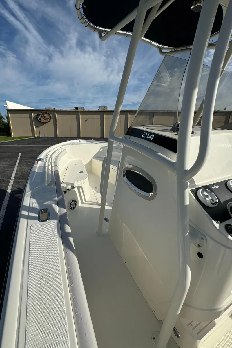 Slide: The Image of 2024 Mako 214 CC center console boat with sleek design and modern features. - 7