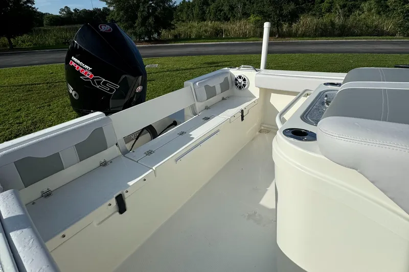 Slide: The Image of 2024 Mako 214 CC boat interior with Mercury Pro XS outboard motor. - 8