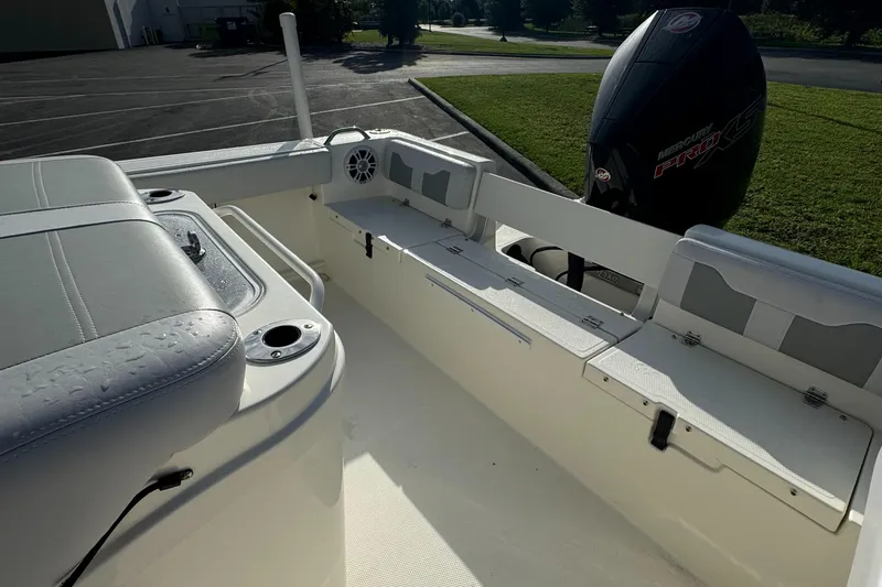 Slide: The Image of 2024 Mako 214 CC boat interior with seating and storage compartments. - 9