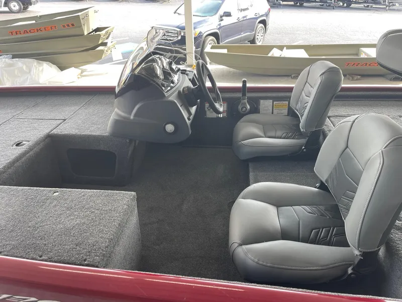 Slide: The Image of 2024 Tracker Pro 170 boat interior with steering console and seating. - 5