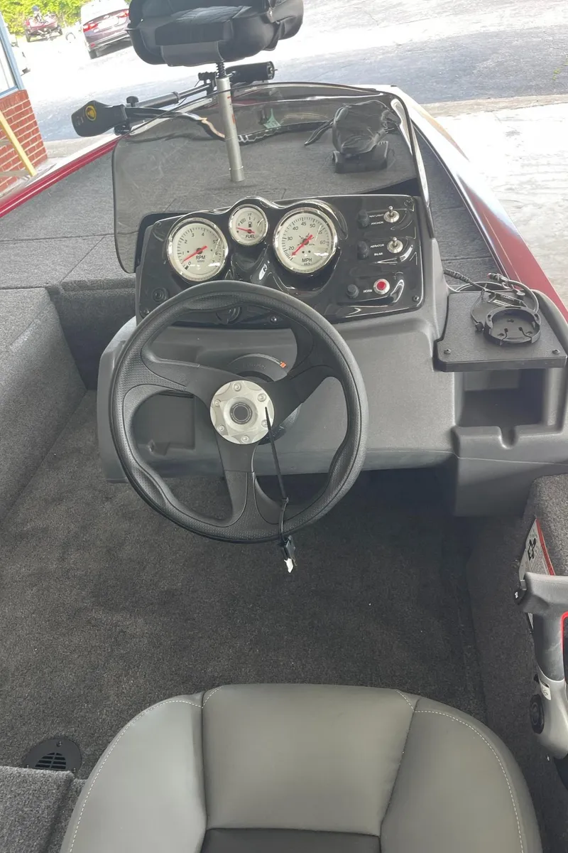 Slide: The Image of 2024 Tracker Pro 170 boat dashboard with steering wheel and gauges. - 6