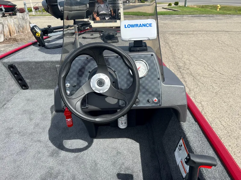 Slide: The Image of 2024 Tracker Bass Tracker Classic XL boat dashboard with steering wheel and Lowrance device. - 2