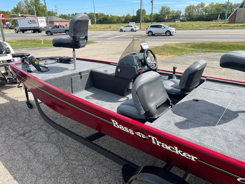 Slide: The Image of 2024 Tracker Bass Tracker Classic XL boat, red exterior, parked near a road. - 4