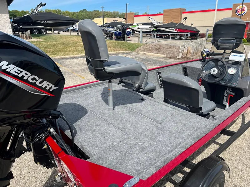 Slide: The Image of 2024 Tracker Bass Tracker Classic XL boat with Mercury engine, gray seating, and control panel. - 5