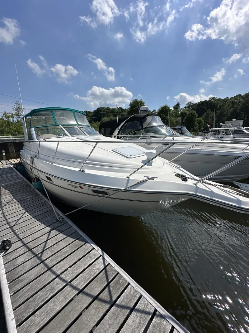 The Image of 1998 Maxum 2800 SCR boat docked at a marina on a sunny day. - 0