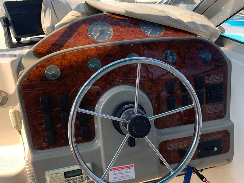 Slide: The Image of 1998 Maxum 2800 SCR boat dashboard with steering wheel and instrument panel. - 12
