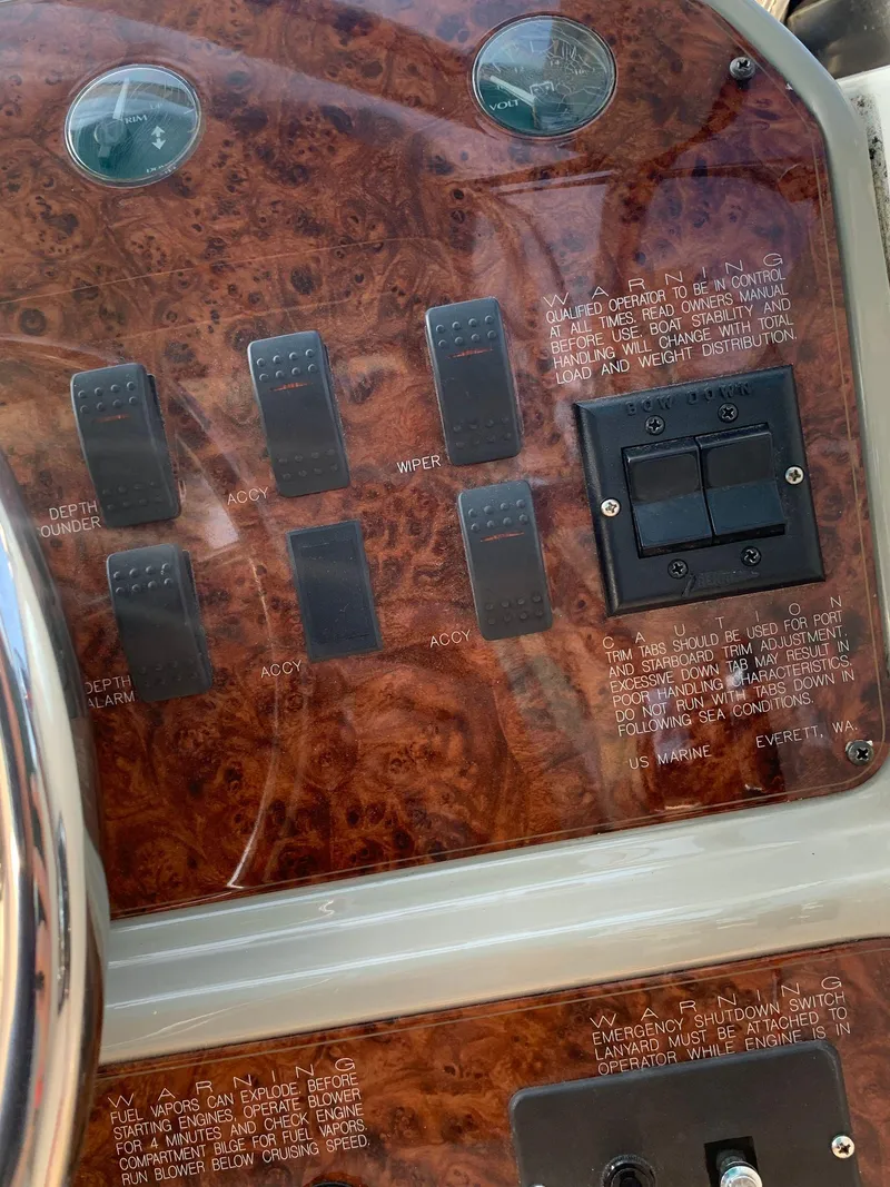 Slide: The Image of Control panel of a 1998 Maxum 2800 SCR boat with switches and labels. - 14