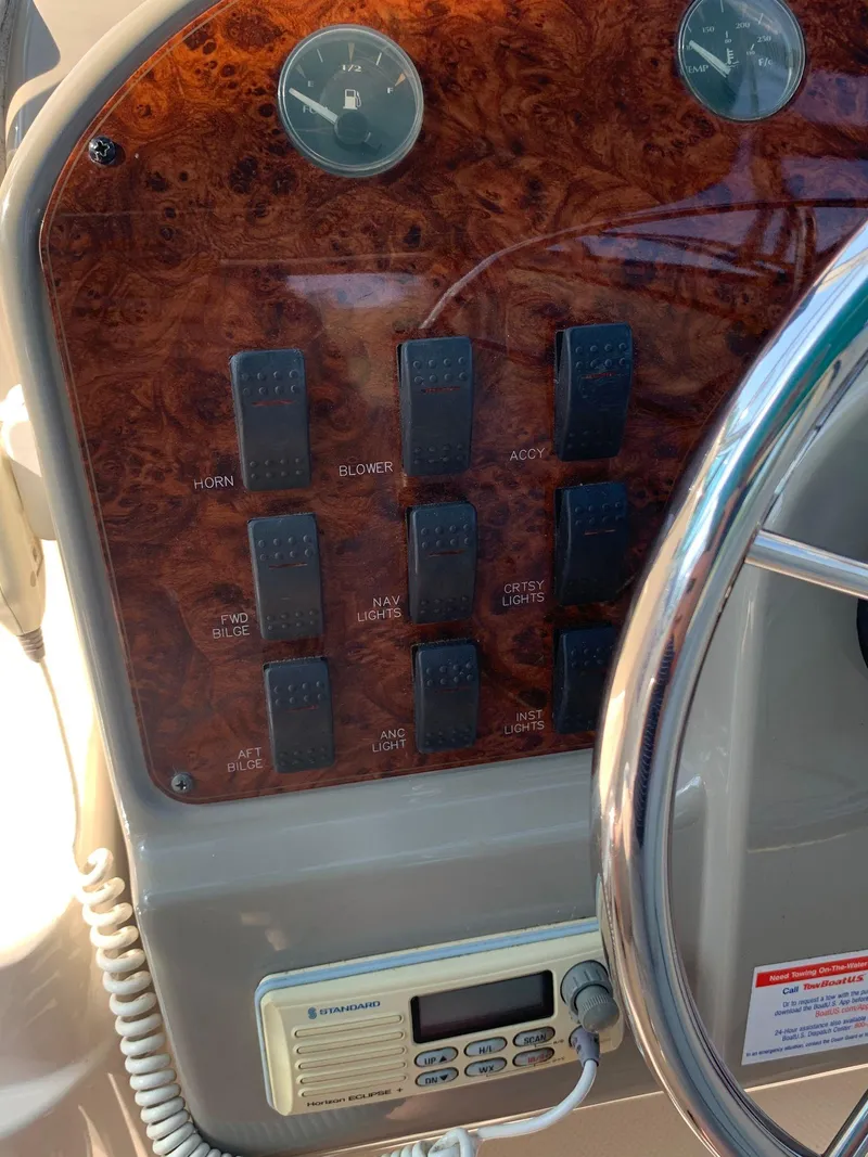 Slide: The Image of Control panel of a 1998 Maxum 2800 SCR boat with switches and gauges. - 15