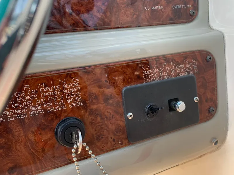 Slide: The Image of Close-up of 1998 Maxum 2800 SCR boat dashboard with warning labels and ignition key. - 16