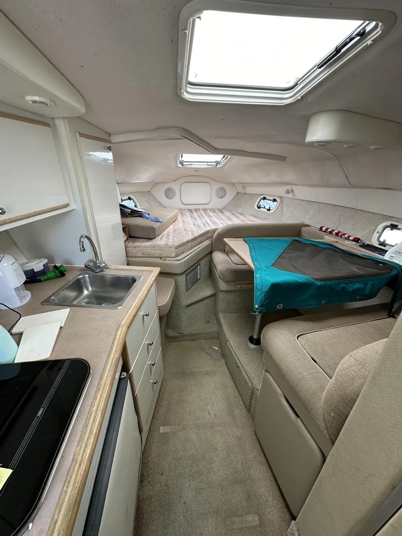 Slide: The Image of 1998 Maxum 2800 SCR cabin interior with kitchenette and seating area. - 24
