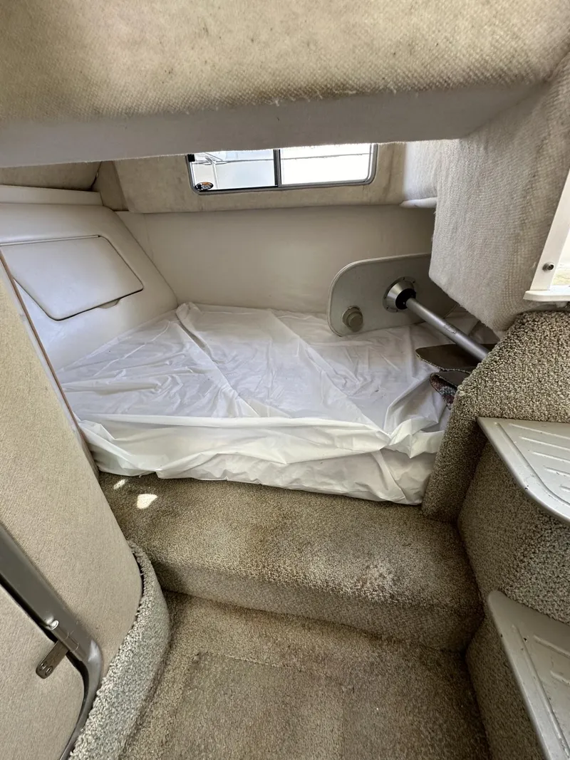Slide: The Image of Interior cabin of a 1998 Maxum 2800 SCR boat with a bed and window. - 30