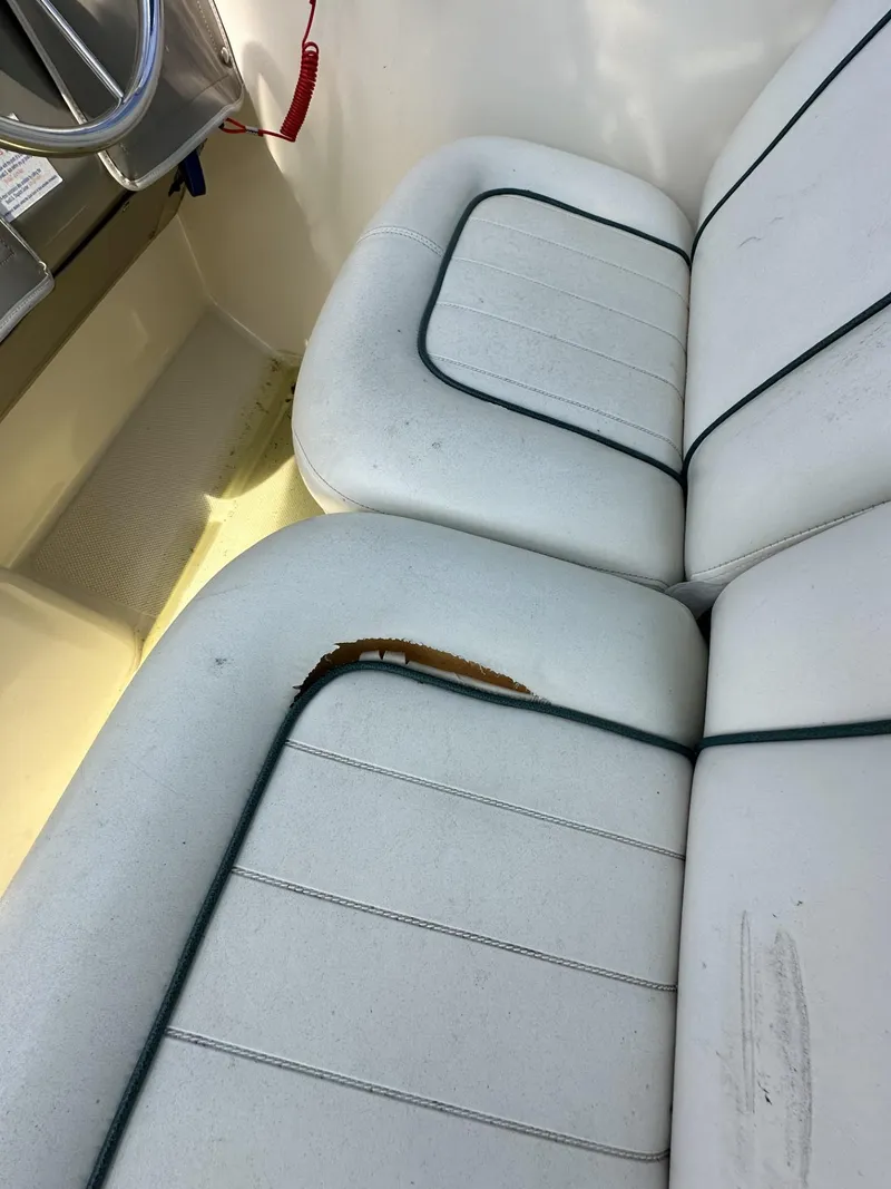 Slide: The Image of 1998 Maxum 2800 SCR boat interior with damaged white seating. - 39