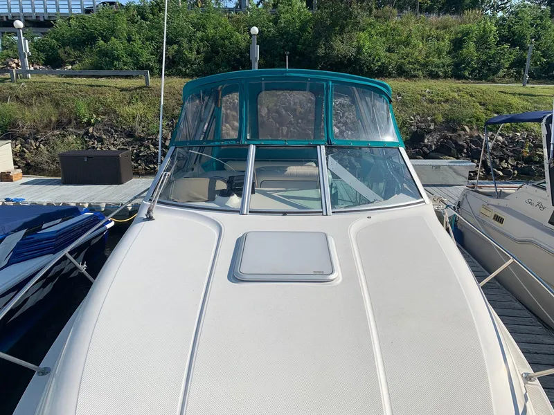 Slide: The Image of 1998 Maxum 2800 SCR boat docked, front view with green canopy. - 4