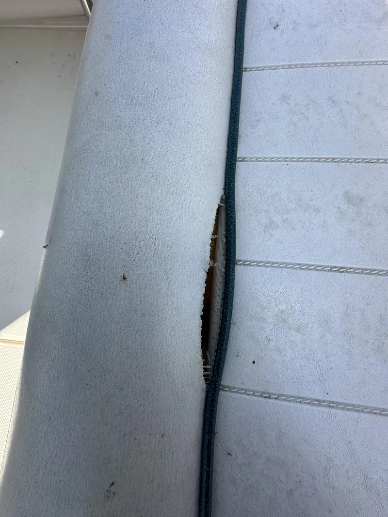 Slide: The Image of Torn upholstery on a 1998 Maxum 2800 SCR boat seat. - 40