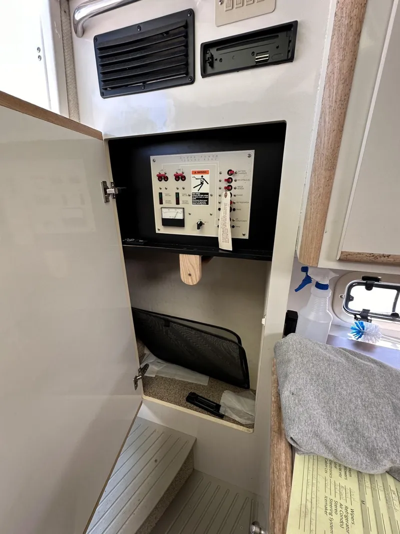 Slide: The Image of Electrical control panel inside a 1998 Maxum 2800 SCR boat cabin. - 42