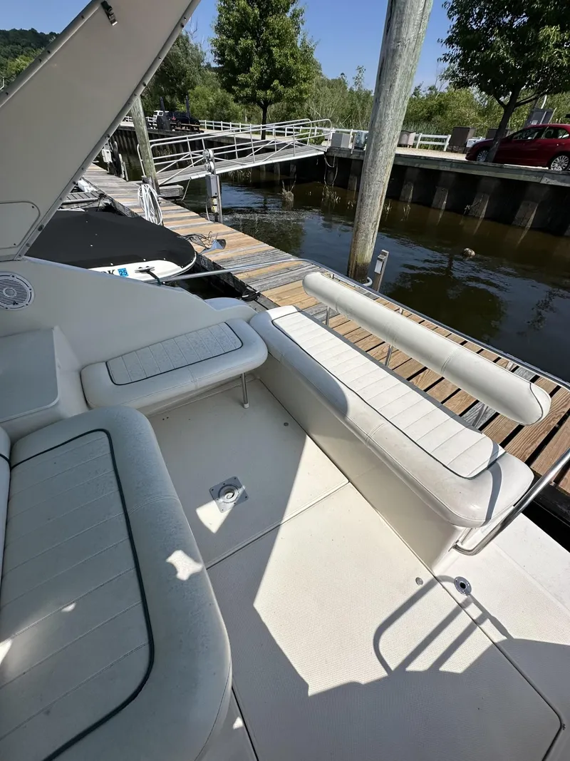 Slide: The Image of 1998 Maxum 2800 SCR boat interior at dock with white seating. - 7