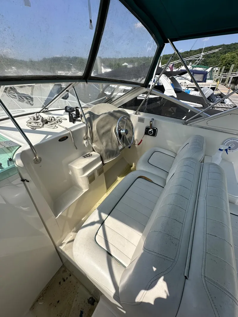 Slide: The Image of 1998 Maxum 2800 SCR boat cockpit with steering wheel and seating. - 9
