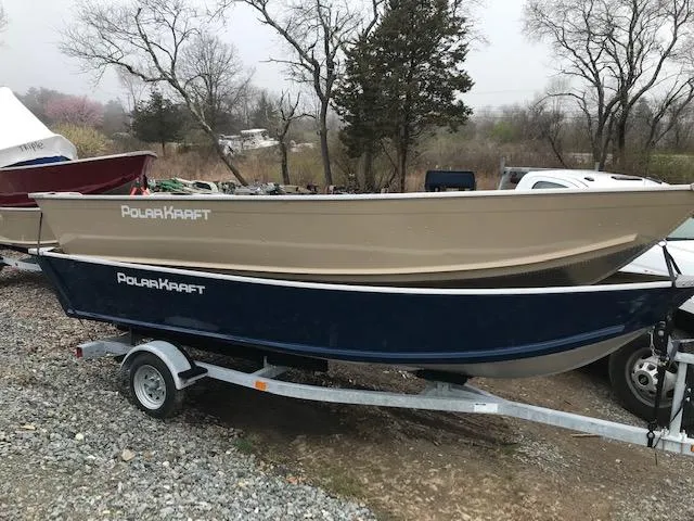 Slide: The Image of 2024 Polar Kraft Dakota 1670L boats on a trailer, beige and blue models. - 2