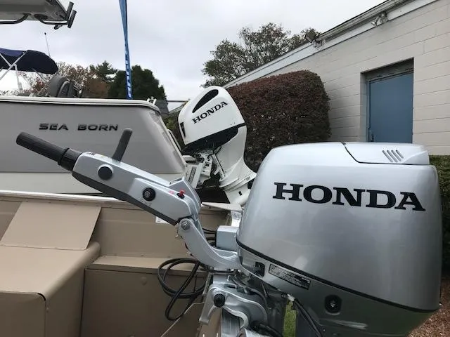 Slide: The Image of Honda outboard motors on Polar Kraft Dakota 1670L boat, 2024 model, docked near Sea Born boat. - 3