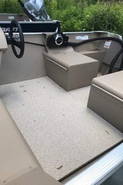 Slide: The Image of 2024 Polar Kraft Dakota 1670L boat interior with steering wheel and seating. - 7