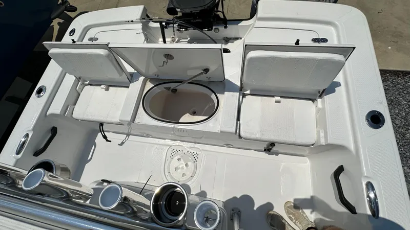 Slide: The Image of 2024 Frontier 2104 boat interior with open storage compartments and fishing rod holders. - 12