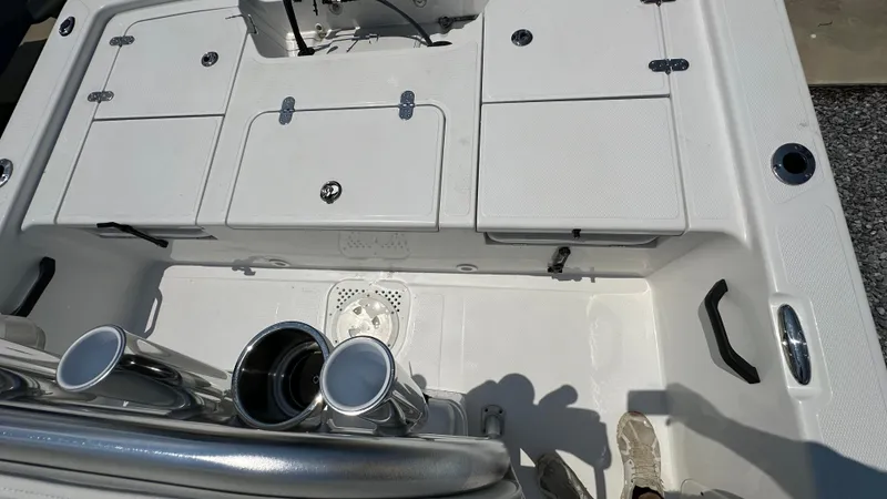 Slide: The Image of 2024 Frontier 2104 boat deck with storage compartments and rod holders. - 13