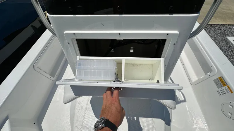 Slide: The Image of 2024 Frontier 2104 boat storage compartment with hand opening lid. - 15