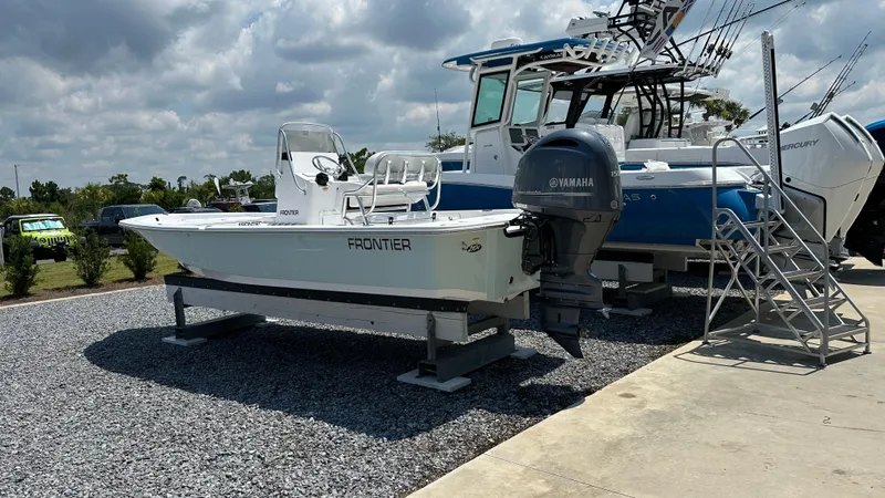 Slide: The Image of 2024 Frontier 2104 boat on display with Yamaha outboard motor. - 4