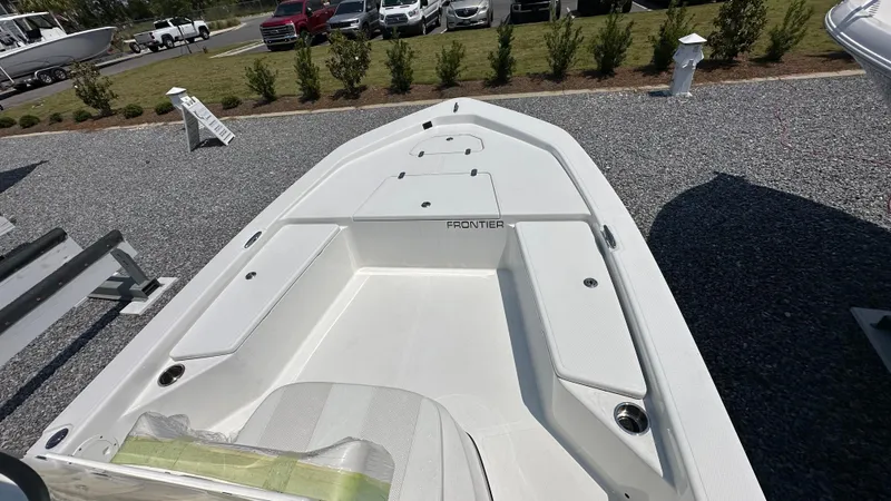 Slide: The Image of 2024 Frontier 2104 boat on display in outdoor showroom. - 6