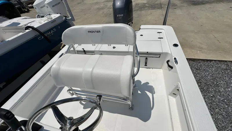 Slide: The Image of 2024 Frontier 2104 boat interior with white seating and steering wheel. - 9