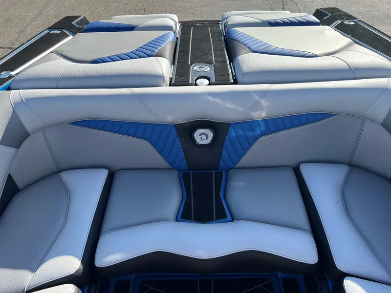 Slide: The Image of 2023 Centurion Fi25 boat interior with blue and gray seating. - 2