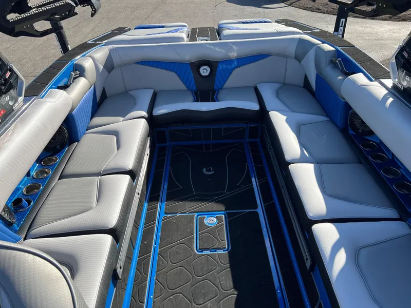 Slide: The Image of 2023 Centurion Fi25 boat interior with blue and gray seating and black flooring. - 4