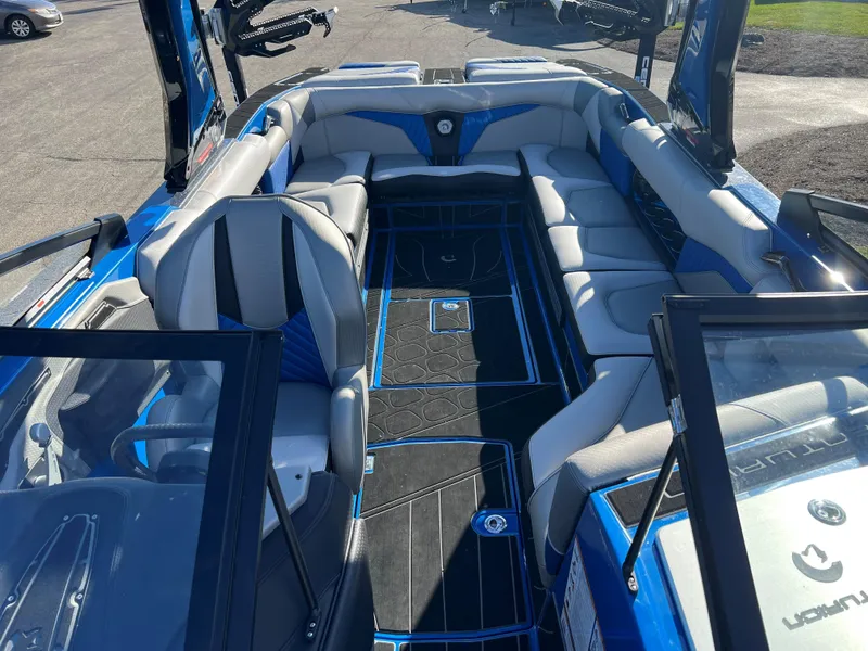 Slide: The Image of 2023 Centurion Fi25 boat interior with blue and gray seating and black flooring. - 5