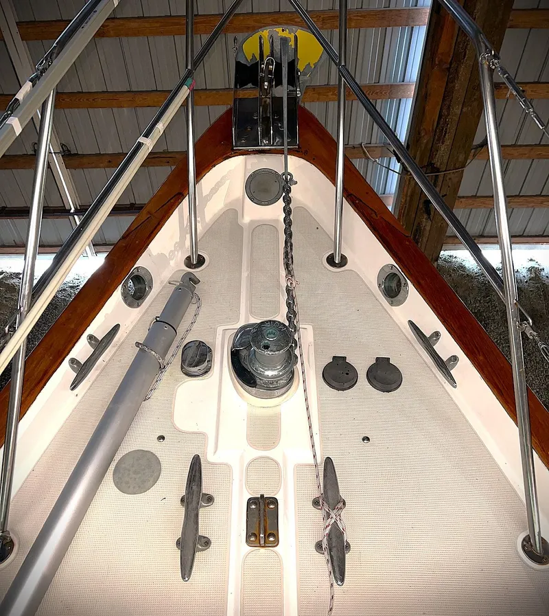Slide: The Image of Bow of 2000 Pacific Seacraft 37 sailboat with anchor chain and deck fittings. - 12