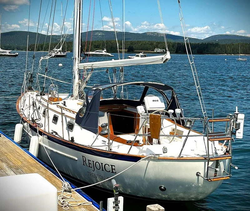 Slide: The Image of Pacific Seacraft 37 sailboat docked, 2000 model, named "Rejoice" on scenic water. - 14