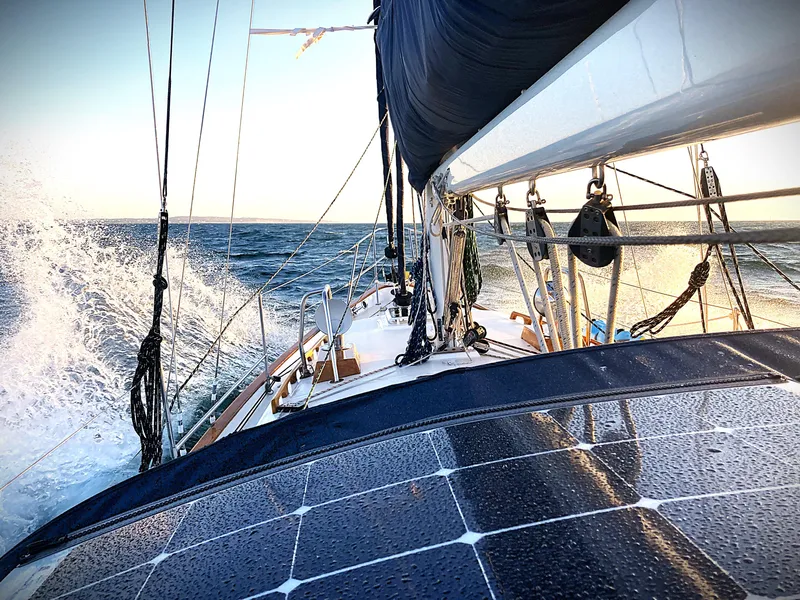 Slide: The Image of Pacific Seacraft 37 sailboat navigating ocean waves, 2000 model, with solar panels on deck. - 15