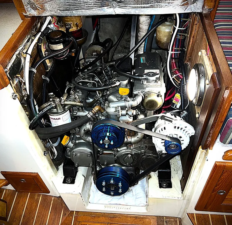 Slide: The Image of Engine compartment of a 2000 Pacific Seacraft 37 sailboat, featuring a Yanmar engine. - 8