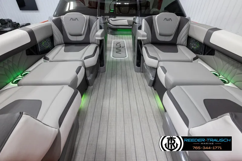 Slide: The Image of 2024 Avalon Excalibur VRB luxury boat interior with gray seating and green LED lighting. - 13