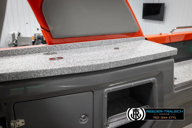 Slide: The Image of 2024 Avalon Excalibur VRB boat interior with granite countertop and storage compartment. - 25