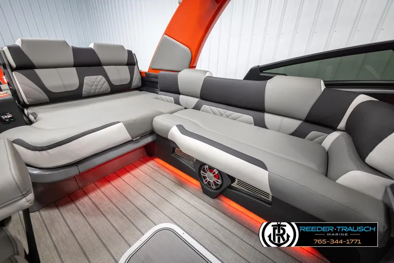 Slide: The Image of 2024 Avalon Excalibur VRB boat interior with gray and black seating, red LED lighting. - 27