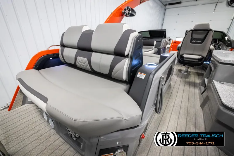 Slide: The Image of 2024 Avalon Excalibur VRB boat interior with gray and black seating, showcased by Reeder-Trausch Marine. - 32
